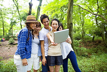 Group of friends at an outdoor party in a forest, Kyoto, Japan