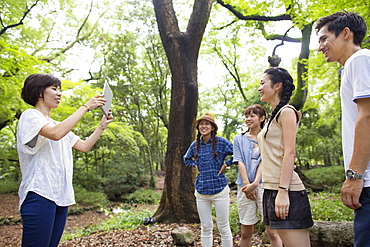 Group of friends at an outdoor party in a forest, Kyoto, Japan