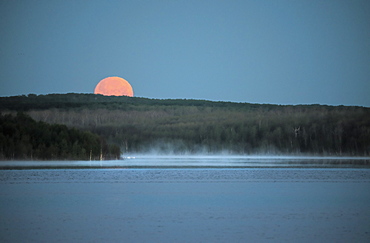 A red moon setting over a lake. MoonlightBlood moon, Saskatchewan, Canada