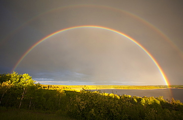 A double rainbow in the sky arching over the land, Rainbow, Saskatchewan, Canada