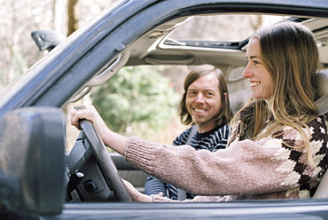 Smiling young couple driving in their car, Millcreek, Utah, United States of America