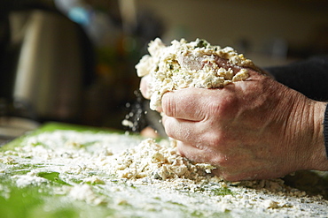 A man mixing flour for fresh pasta, England, United Kingdom