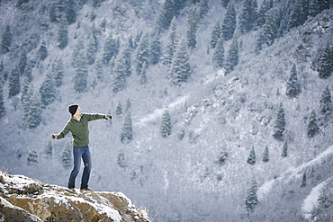 A man on a rock outcrop in the mountains, Mountains, Utah, USA