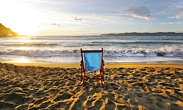 A beach chair on the sand and a sunset on the horizon, Beach, Mexico