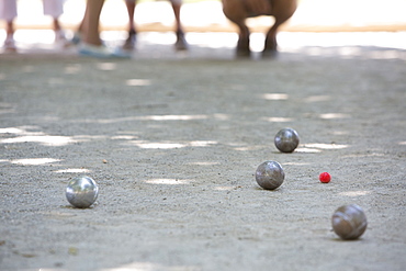 A boules game in progress on the sandy ground in the shade, Game of Boules, France