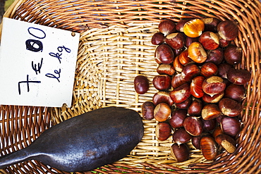 A basket of roasted sweet edible chestnuts, France