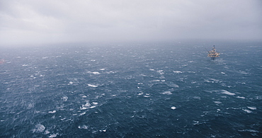 A ship sailing in the North Sea in foggy, rough conditions.