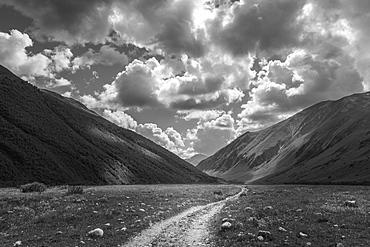 Mountainous landscape with rural path under a cloudy sky, Georgia, Georgia