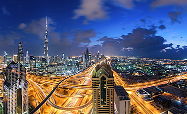 Cityscape of Dubai, United Arab Emirates at dusk, with the Burj Khalifa and other skyscrapers and illuminated highway in the centre, Dubai, United Arab Emirates