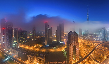 Cityscape with illuminated skyscrapers in Dubai, United Arab Emirates at dusk, Dubai, United Arab Emirates