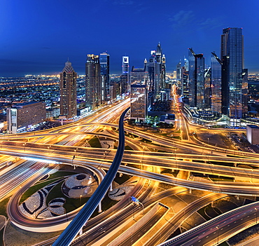 Cityscape of Dubai, United Arab Emirates at dusk, with skyscrapers and illuminated highways in the foreground, Dubai, United Arab Emirates