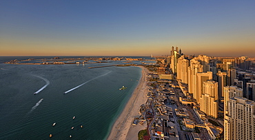 Cityscape of Dubai, United Arab Emirates at dusk, with skyscrapers lining coastline of the Persian Gulf, Dubai, United Arab Emirates