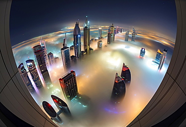 Aerial view of cityscape with illuminated skyscrapers above the clouds in Dubai, United Arab Emirates at dusk, Dubai, United Arab Emirates