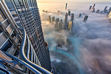 Aerial view of cityscape with skyscrapers above the clouds in Dubai, United Arab Emirates, Dubai, United Arab Emirates