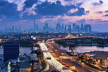 Cityscape of the Dubai, United Arab Emirates at dusk, with highway across the marina and skyscrapers in the distance, Dubai, United Arab Emirates