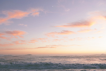 Seascape with cloudy sky at sunset.