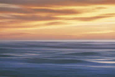 Seascape with cloudy sky at sunset.