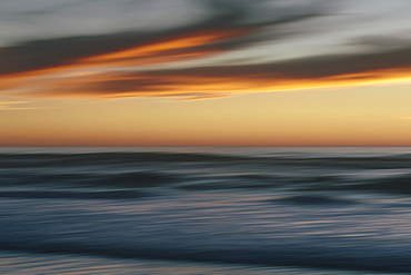 Seascape with cloudy sky at sunset.