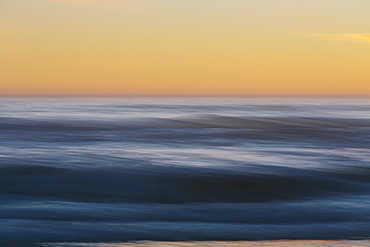 Seascape with cloudy sky at sunset.