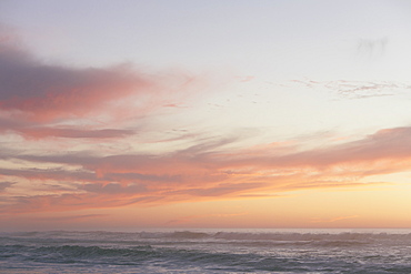 Seascape with cloudy sky at sunset.