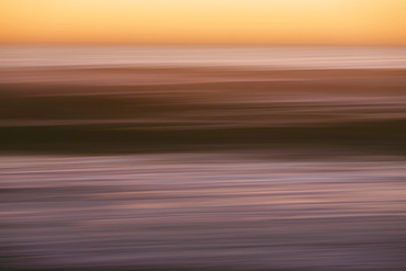 Abstract seascape with horizon over ocean at dusk.