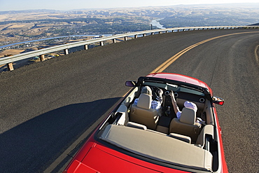 Young Caucasian couple on a road trip in their convertible sports car near Lewiston, Idaho USA, United States of America