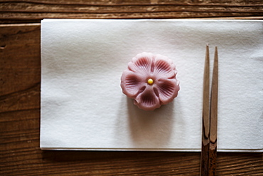 High angle close up of pair of chopsticks and Wagashi, a sweet traditionally served during a Japanese Tea Ceremony, Kyushu, Japan