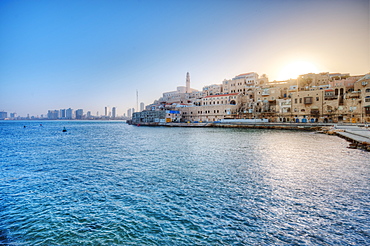 Sun rising over waterfront town, Israel, Israel