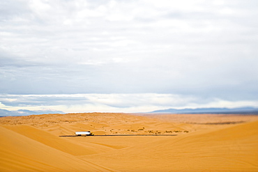 Truck Driving Through Desert, Imperial Sand Dunes, California, United States of America