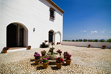 Flowerpots around fountain outside villa, Antequera, Andalucia, Spain