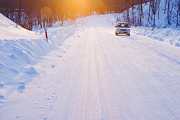 Car on Snow Covered Road, Hokkaido, Japan