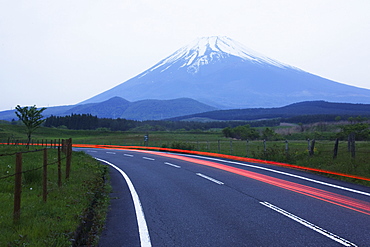 Blurred headlights on road before mountain, Japan, Japan