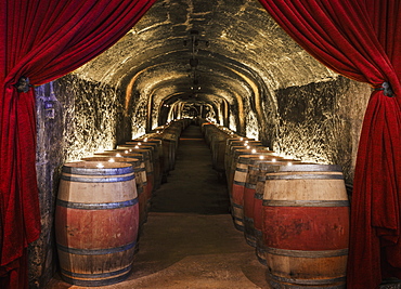 Candles on wine barrels in cave cellar, NAPA, California, USA