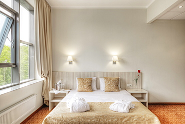 Folded robes on bed in hotel room, Moscow, Russia