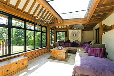 Cushioned benches in sunny conservatory, Farnham Royal, Buckinghamshire, UK