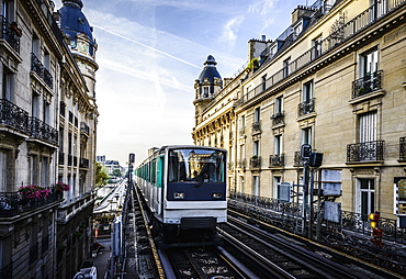 Streetcar passing between apartment buildings, Paris, France, Paris, France