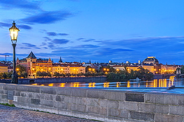 Charles Bridge and city illuminated at dawn, Prague, Czech Republic