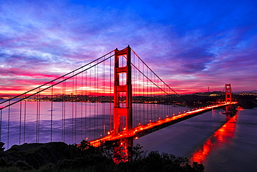 Golden Gate Bridge lit up at sunset, San Francisco, California, United States