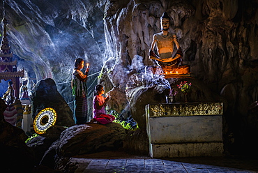 Asian girls lighting incense in temple