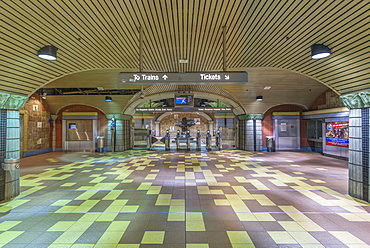 Turnstiles and signs in subway station