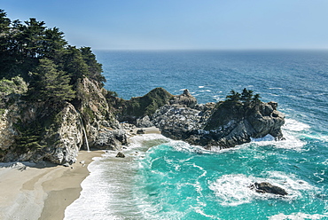 Aerial view of waves washing up on rocky beach