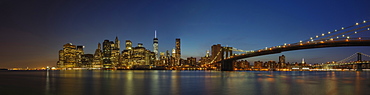 Panoramic view of New York city skyline illuminated at night, New York, United States