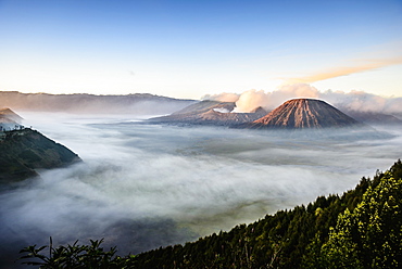 High angle view of clouds under smoking volcano