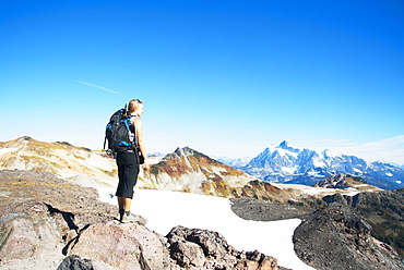 Woman admiring mountains in remote landscape