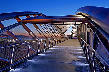 Illuminated footbridge over Seattle cityscape at night, Washington, United States