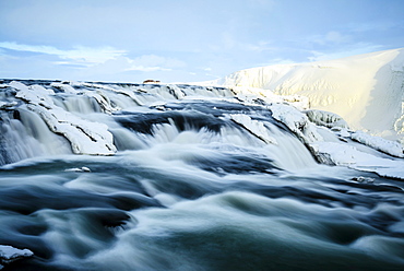 Time lapse view of river flowing over icy rock formations, Gullfoss, Iceland