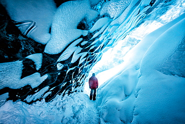 Hiker walking in ice cave, Jokulsarlon, Iceland