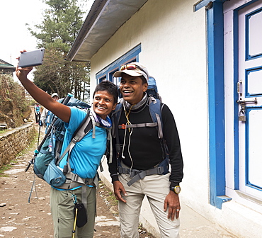 Tourists posing for cell phone selfie, Lukla, Khumbu, Nepal