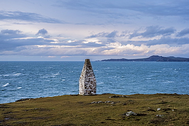 Cardigan Bay and stone cairn marking the entrance to Porthgain Harbour from the Pembrokeshire Coast Trail, Pembrokeshire National Park, Wales, UK, Pembrokeshire National Park, Wales