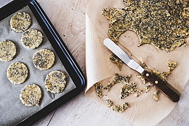 High angle close up of seeded cracker dough on a baking tray, England